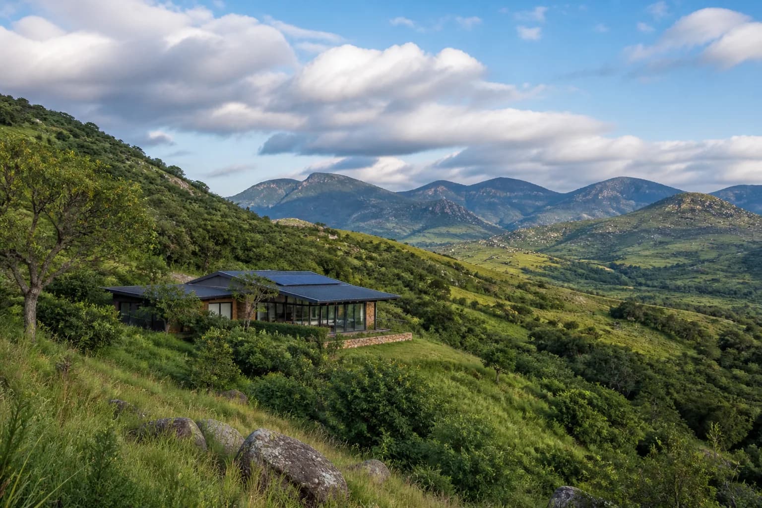 Home nestled in green Zimbabwe hills under an open sky